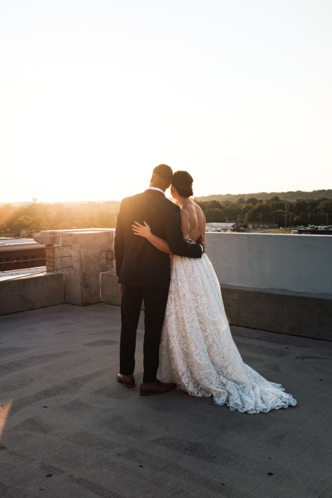 Bridal couple enjoying a quiet moment at sunset before dancing the night away with loved ones.